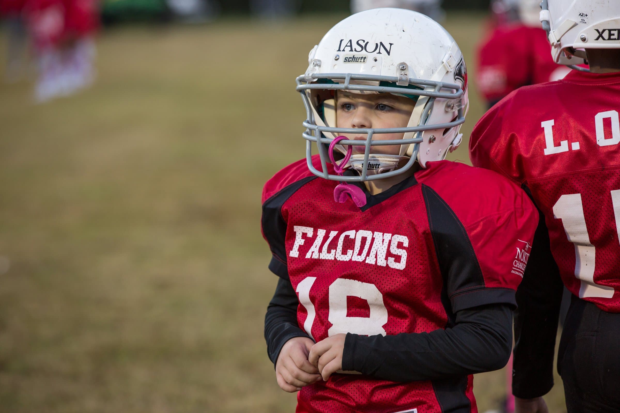 North Charleston youth football player in a white helmet and red Falcons jersey