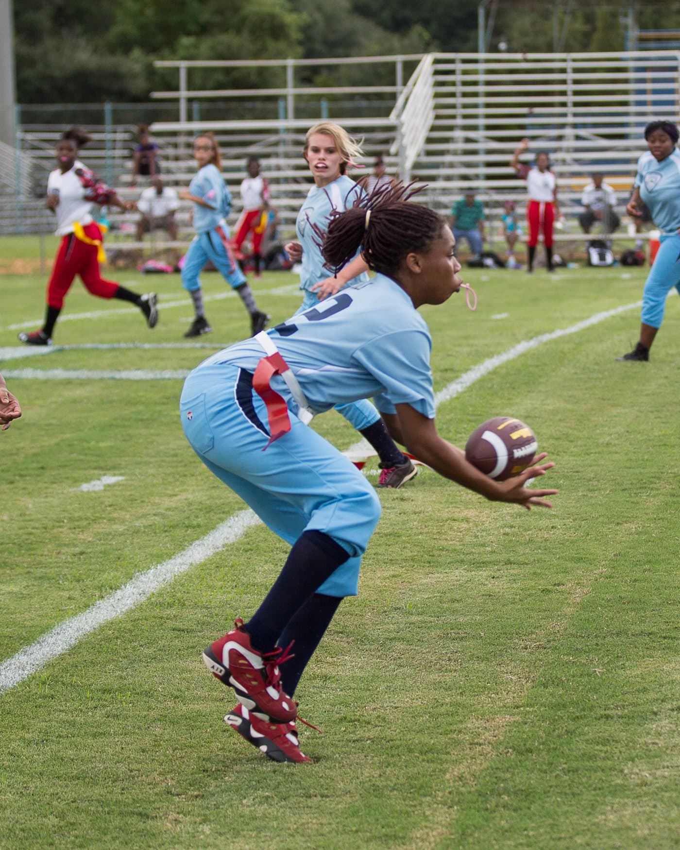 Kids playing flag football at golden hour