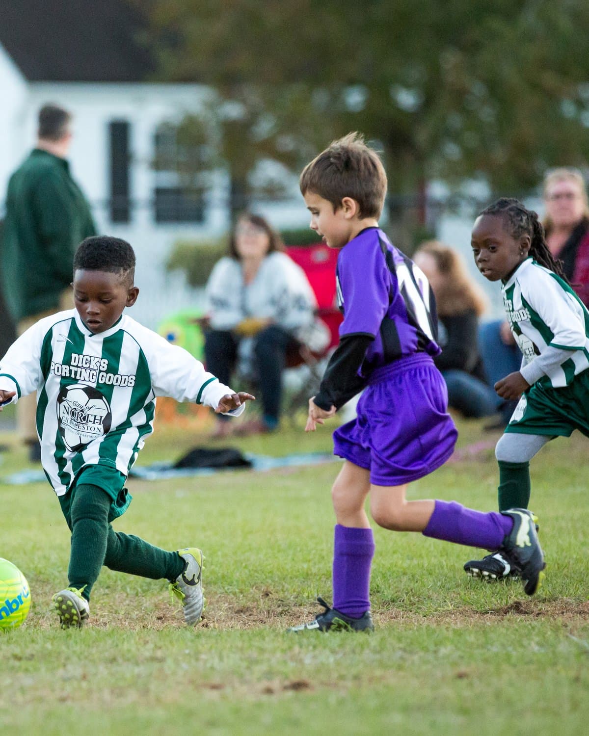 North Charleston youth soccer — player striking the ball mid-game